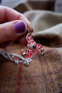 Sterling silver Zoomorphic triskellion from Faversham with Enamel and garnet
